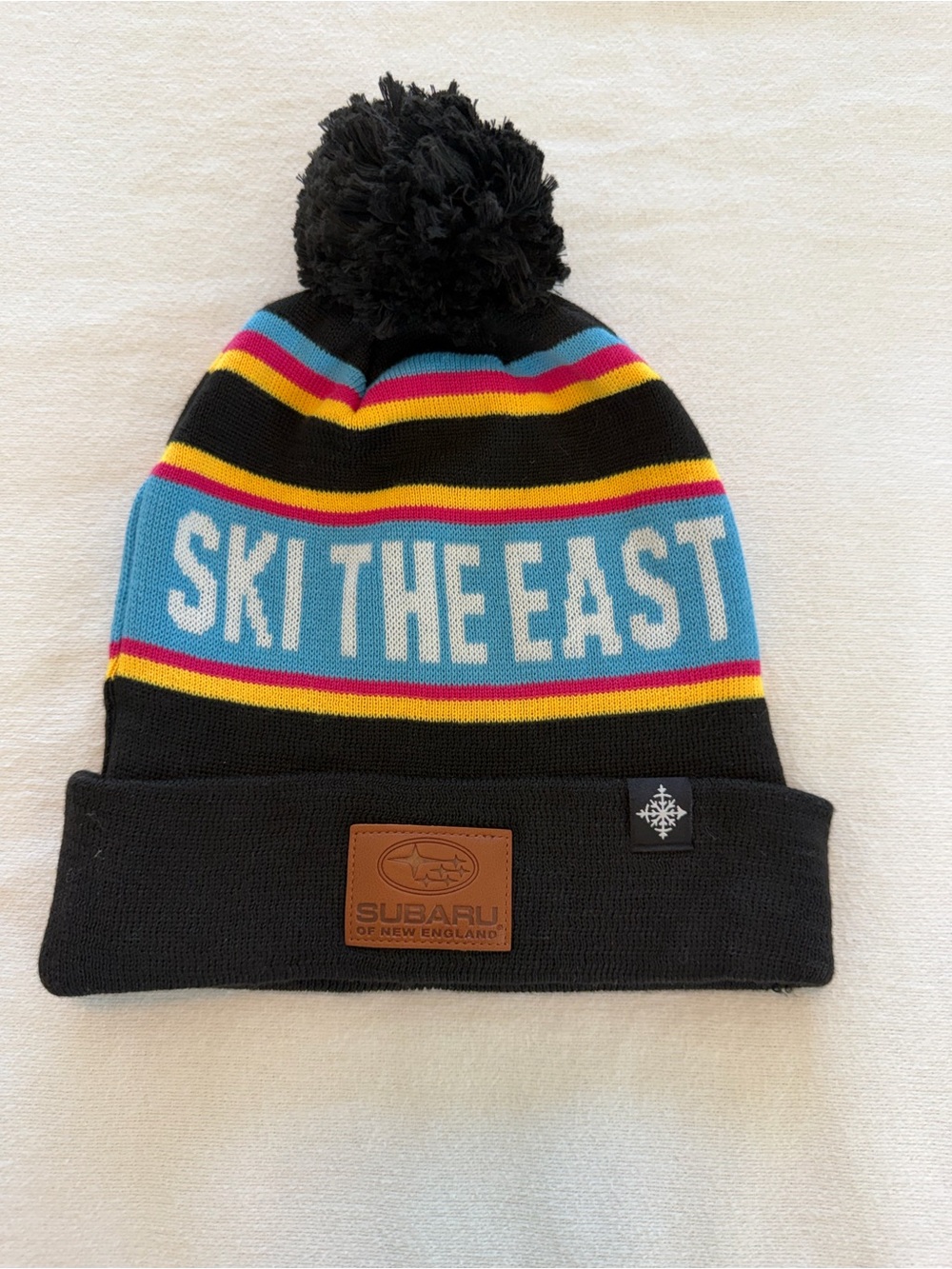 Subaru “Ski The East” Pom Beanie - Black with‎ Multicolor Stripes